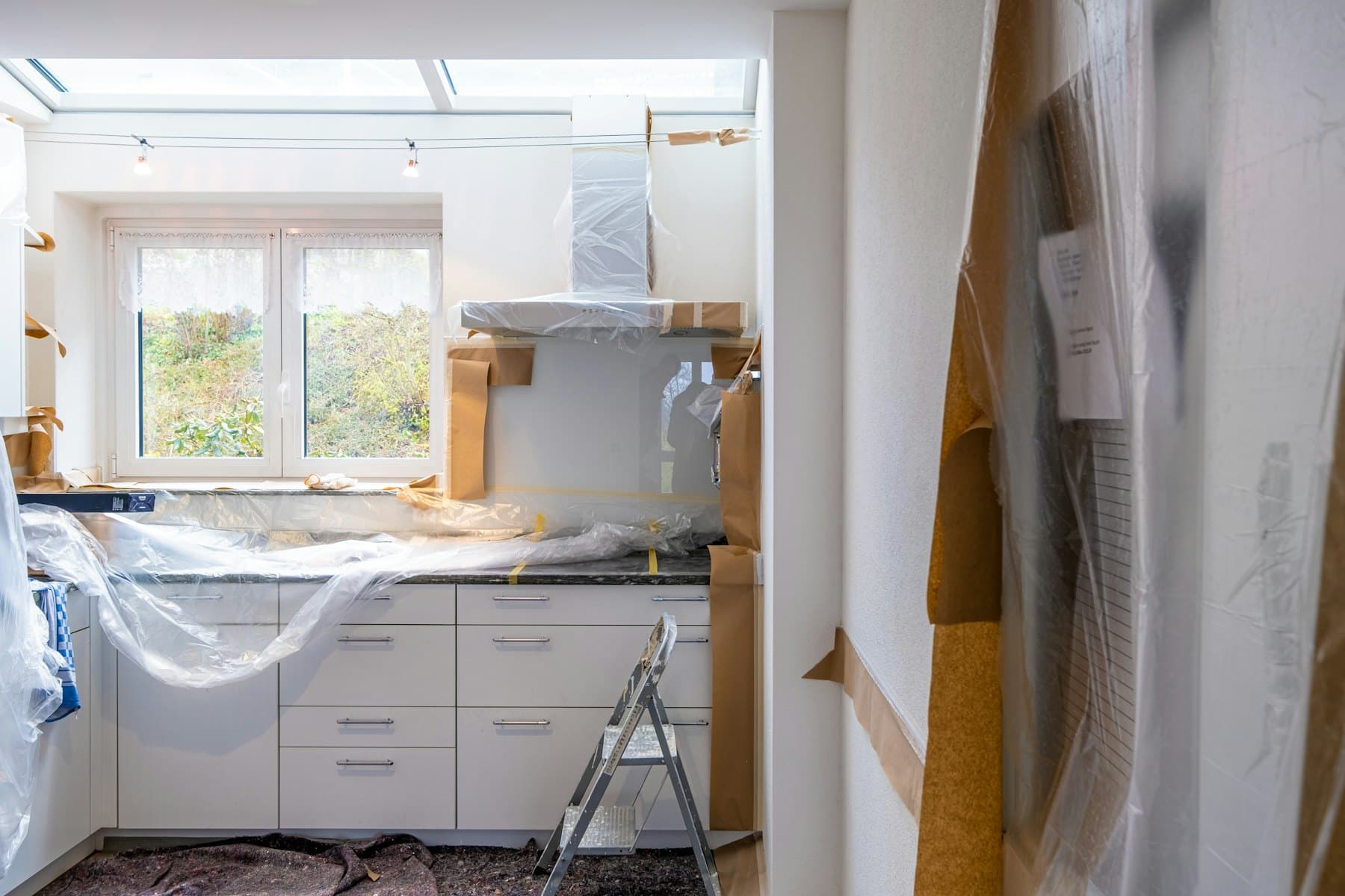 Kitchen units covered with protective sheeting during works